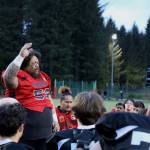 Team World coach and player Lino Fenumiai says a prayer over both teams after the Juneau Alumni Football game Friday evening at Adair-Kennedy Field. (Clarise Larson / Juneau Empire)