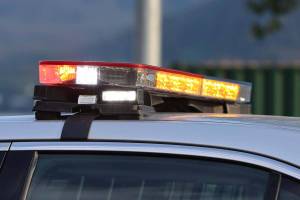 Emergency lights flash on top of a police car. (Ben Hohenstatt / Juneau Empire File)
