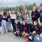 The Juneau-Douglas High School: Yadaa.at Kalé Crimson Bears girls soccer team pose with snacks after their loss to North Pole in the ASAA DII Girls Soccer State Championships, Saturday, at West Anchorage High School (Courtesy Photo / JDHS Soccer)