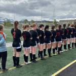 The Juneau-Douglas High School: Yadaa.at Kalé Crimson Bears girls soccer team line up before their third/fifth place game against North Pole in the ASAA DII Girls Soccer State Championships, Saturday, at West Anchorage High School. (Courtesy Photo / JDHS Soccer)
