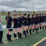 The Juneau-Douglas High School: Yadaa.at Kalé Crimson Bears girls soccer team line up before their third/fifth place game against North Pole in the ASAA DII Girls Soccer State Championships, Saturday, at West Anchorage High School. (Courtesy Photo / JDHS Soccer)