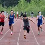 Ketchikan sophomore Jason Lorig, center, wins the 100-meter dash at the Region V Track & Field Championships, Saturday, May 20, at Thunder Mountain High School. (Klas Stolpe / Juneau Empire)