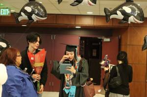 Kaydence Ernzen sheds tears of joy after getting a surprise call from her father minutes after she graduated from Yaakoosgé Daakahídi High School on Sunday. Her father was in the Philippines on the day of the ceremony as Ernzen graduated months earlier than originally anticipated. (Mark Sabbatini / Juneau Empire)