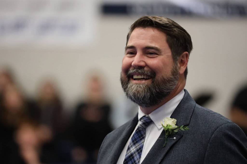 Thunder Mountain High School principal Shawn Arnold smiles as a student walks to him to receive their diploma during the 2023 graduation ceremony Sunday afternoon. (Clarise Larson / Juneau Empire)