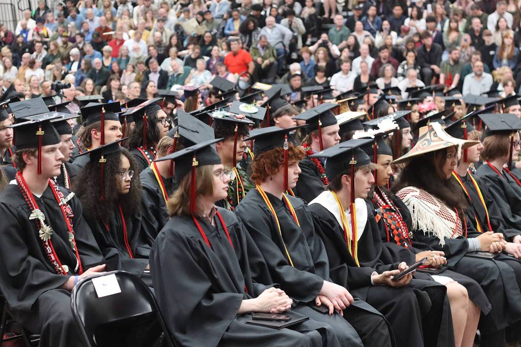 Seniors at Juneau-Douglas High School: Yadaa.at Kalé listen to final words of wisdom from speakers just before the conclusion of their graduation ceremony Sunday. (Mark Sabbatini / Juneau Empire)