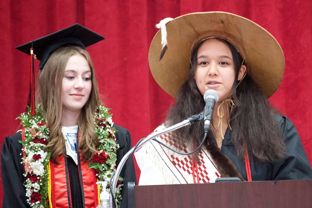 Carlynn Casperson and Jossline Aranda-Jackson, seniors at Juneau-Douglas High School: Yadaa.at Kalé, deliver the Tlingit land acknowledgement at the opening of their schools graduation ceremony Sunday. Caspersons mother, Paula, is schools principal. (Mark Sabbatini / Juneau Empire)