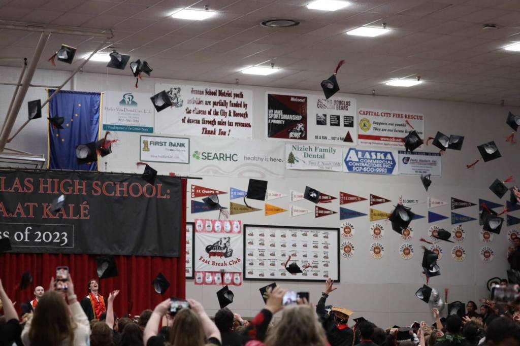 About 140 students at Juneau-Douglas High School: Yadaa.at Kalé toss their caps in the air after receiving the diplomas during Sundays graduation ceremony. (Clarise Larson / Juneau Empire)