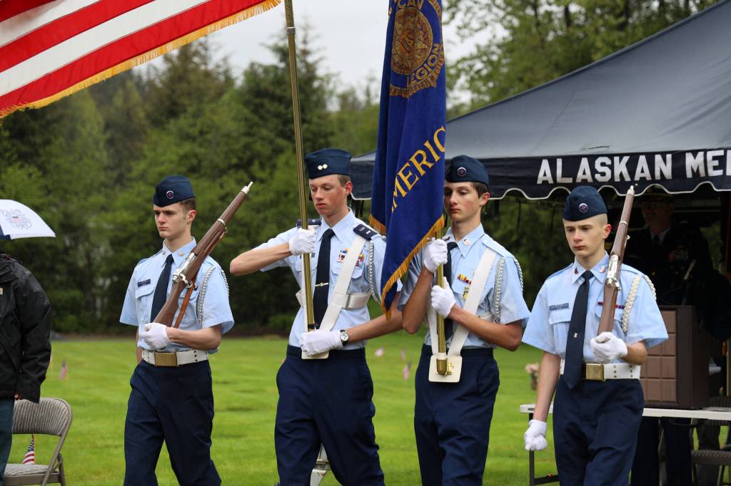 Cadet Staff Sgt. Casey Knapp (left) Cadet 1st Lt. Elijah Goins (left center) Cadet Master Sgt. Gunner Lotz (right center) and Cadet Senior Airman Wesson Lotz (right) lead the color guard exit at Alaskan Memorial Park for a service in observance of Memorial Day on Monday morning. (Clarise Larson / Juneau Empire)