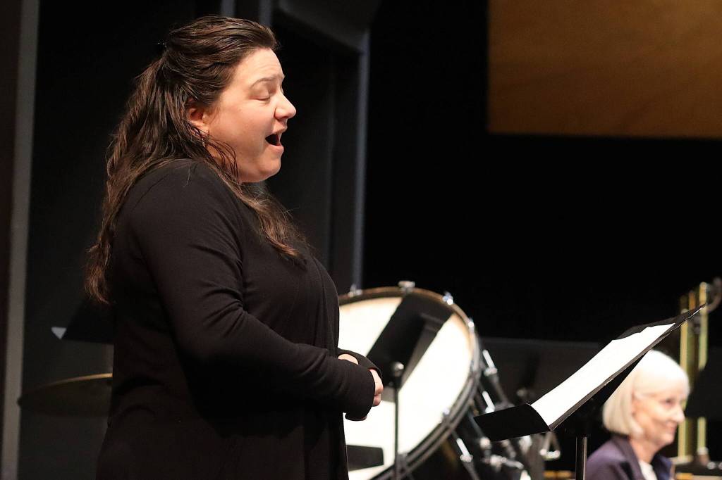 Sara Radke Brown sings a composition from The Lord of the Rings film trilogy during a concert rehearsal Tuesday at Juneau-Douglas High School: Yadaa.at Kalé. Two concerts this weekend will feature the first vocal performances ever under current music director Christopher Koch. (Mark Sabbatini / Juneau Empire)