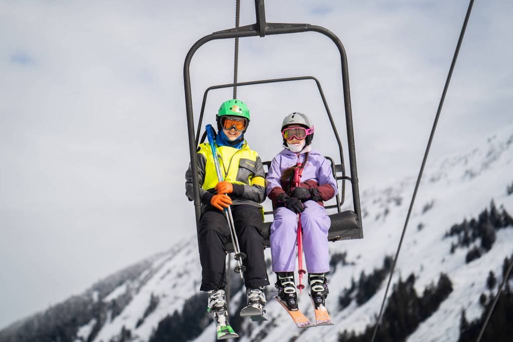 Sitka participant Marina Marley (left), shares a ride on the chairlift with Juneau participant Kiana Twitchell (right) during the final Douglas Indian Association Snow Camp of the 2022-2023 season. (Photo by Lee House / Sitka Conservation Society)