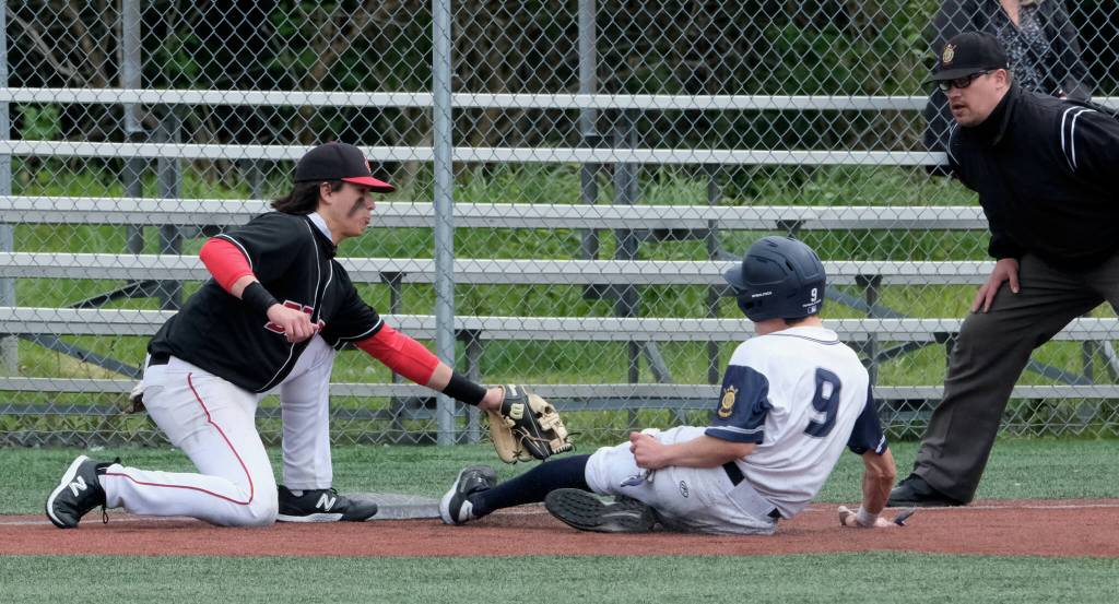 JDHS junior third baseman Landon Simonson tags out an Eagle River base runner during the Crimson Bears 2-1 loss to the Wolves in an elimination game Friday at the ASAA Division I State Baseball Championships on Sitkas Moller Field. (Klas Stolpe / Juneau Empire)