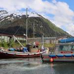 The City and Borough of Juneau Harbormaster Enforcement vessel drives past the Dusky Rock which sits at Aurora Harbor. The vessel was towed there from Sandy beach Friday evening after three people died within a three-day period aboard the vessel while anchored offshore. (Clarise Larson / Juneau Empire)
