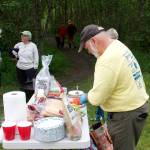 Trail Mix Vice President Ron Bressette prepares fixings for a cookout for workers who spent Saturday morning improving the Kingfisher Pond Loop Trail. (Mark Sabatini / Juneau Empire)