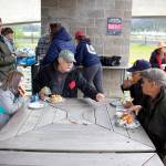 Local residents from a diverse range of ages and cultures gather for a cookout Sunday at Bill Overstreet Park after participating in an annual walk celebrating National Cancer Survivors Day. (Mark Sabbatini / Juneau Empire)