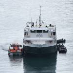 A lifeboat from the Sapphire Princess cruise ship loads passengers and crew from the Wilderness Discoverer after an engine fire on the vessel Monday morning. No significant injuries were reported and U.S. Coast Guard officials said the disabled vessel will be towed to Ketchikan. (Photo by Dan Reilly)