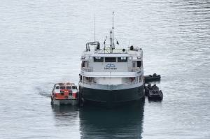 A lifeboat from the Sapphire Princess cruise ship loads passengers and crew from the Wilderness Discoverer after an engine fire on the vessel Monday morning. No significant injuries were reported and U.S. Coast Guard officials said the disabled vessel will be towed to Ketchikan. (Photo by Dan Reilly)