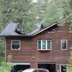Portions of the roof of a home in the Fritz Cove area near Fox Farm Trail are caved in following a structure fire Tuesday morning. No injuries were reported. (Clarise Larson / Juneau Empire)