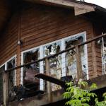 Broken windows and portions of the roof of a home in the Fritz Cove area near Fox Farm Trail are caved in following a structure fire Tuesday morning. No injuries were reported. (Clarise Larson / Juneau Empire)