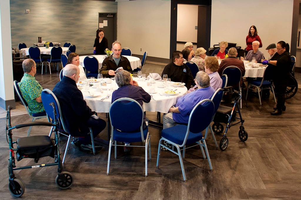 About 15 residents at Riverview Senior Living, as well as some visiting family members, eat dinner Wednesday night in the newly opened assisted living complex. The facility has nearly 90 apartments, which officials said residents will move into gradually during the coming months to ensure a smooth startup. (Mark Sabbatini / Juneau Empire)