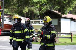 Capital City Fire/Rescue officials respond to a trailer fire that was reported at the Switzer Village Mobile Home Park in the Lemon Creek area Wednesday afternoon. No one was in the trailer at the time of the fire, and no injuries have been reported, officials say. (Clarise Larson / Juneau Empire)
