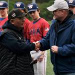 Lawrence Woody Widmark shakes hands with Alaska School Activities Association executive director Billy Strickland after being presented with the ASAA Gold Lifetime Pass at the ASAA State Baseball Championships in Sitka last week. (Klas Stolpe / Juneau Empire)