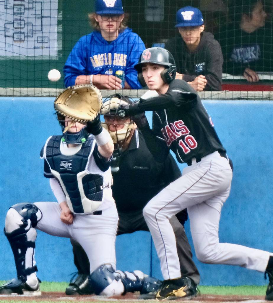 Home plate umpire Lawrence Woody Widmark watches a pitch to JDHS senior batter Joe Aline during the Alaska School Activities Association State Baseball Championships in Sitka last week. Widmark was honored with the ASAA Gold Lifetime Pass at the tournament. (Klas Stolpe / Juneau Empire)