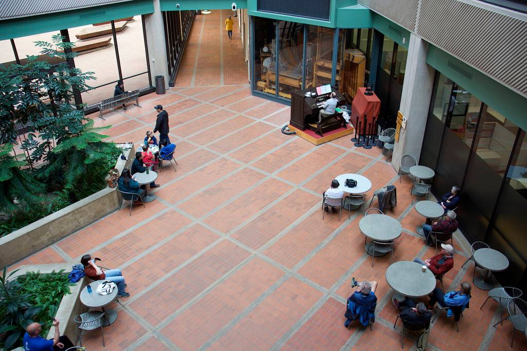 An audience of state workers, other Juneau residents and visitors listens to a concert by J. Allan MacKinnon on the 1928 Kimball Theatre Pipe Organ in the Alaska State Office Building on Friday. The concerts were a mainstay in the building for decades until the COVID-19 pandemic halted them for more than three years. The first show since the disruption took place with little advance public notice. (Mark Sabbatini / Juneau Empire)