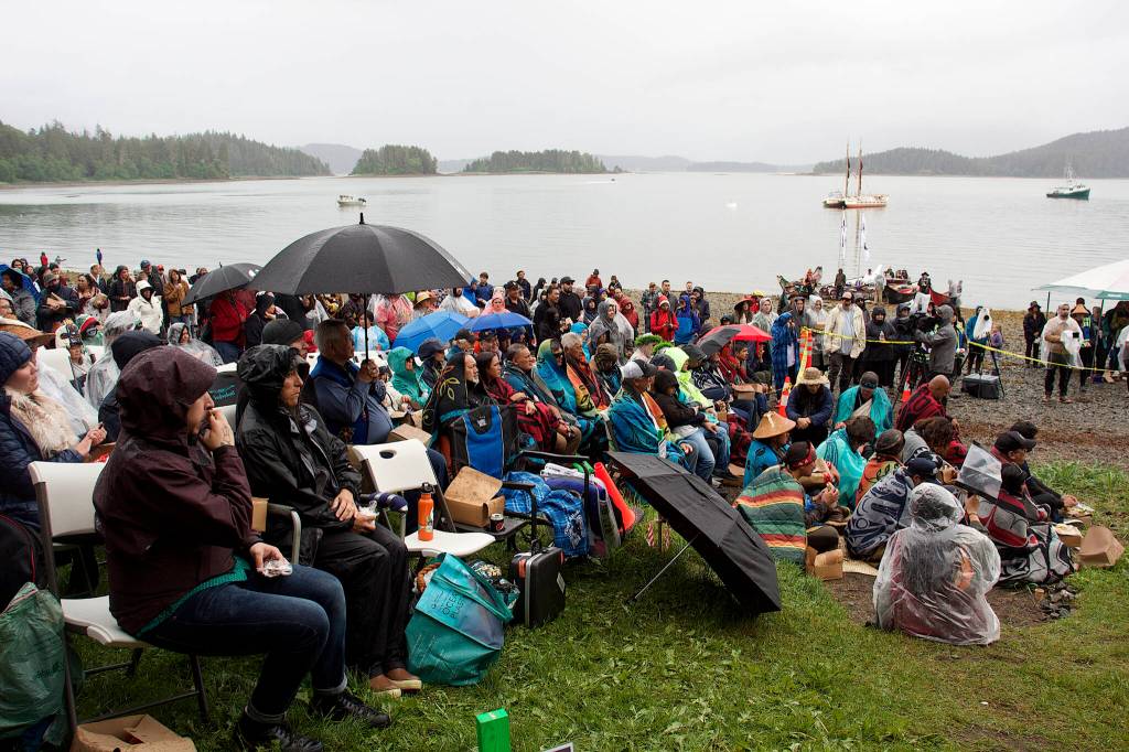 A crowd of hundreds don raincoats as they listen to the welcoming ceremony of the Moananuiākea voyage and Hōkūlea which arrived at Auke Bay Saturday afternoon. (Mark Sabbatini / Juneau Empire)