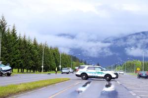 A police vehicle blocks the left turn lane from Egan Drive into Yandukin Drive on Saturday after a two-vehicle collision killed one person and seriously injured four others. Changes intended to improve drivers line of sight when making left turns on both sides of Egan Drive are scheduled to be complete by October. But state officials said Monday more significant changes recommended in a 2021 study, including a traffic signal and an alternative detour lane, are still on hold and will likely take a long time to get through the regulatory process. (Clarise Larson / Juneau Empire)