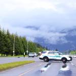 A police vehicle blocks the left turn lane from Egan Drive into Yandukin Drive on Saturday after a two-vehicle collision killed one person and seriously injured four others. Changes intended to improve drivers line of sight when making left turns on both sides of Egan Drive are scheduled to be complete by October. But state officials said Monday more significant changes recommended in a 2021 study, including a traffic signal and an alternative detour lane, are still on hold and will likely take a long time to get through the regulatory process. (Clarise Larson / Juneau Empire)