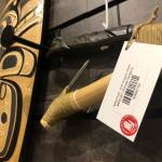 Artwork for sale at the Sealaska Heritage Institute shop on Friday bears a label declaring it compliant with the Indian Arts and Crafts Act. The federal government has filed several recent cases in Alaska for violations of the act. (Photo by James Brooks/Alaska Beacon)