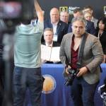Jeremy Cubas shot photos of Gov. Mike Dunleavy last month at the Alaska Sustainable Energy Conference in Anchorage. (Nathaniel Herz for Alaska Public Media)