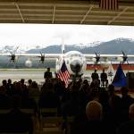 Coast Guard officials are silhouetted by rescue aircraft during a change of command ceremony on June 9 in Juneau. (Photo by James Brooks/Alaska Beacon)