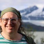 Emily Mesch, president of Southeast Alaska LGBTQ+ Alliance, smiles for a photo near the Mendenhall Glacier Thursday evening. SEAGLA is a Juneau-based nonprofit that works to provide a supporting social network for gay, lesbian, bisexual, transgender, and queer people in Southeast Alaska. (Clarise Larson / Juneau Empire)