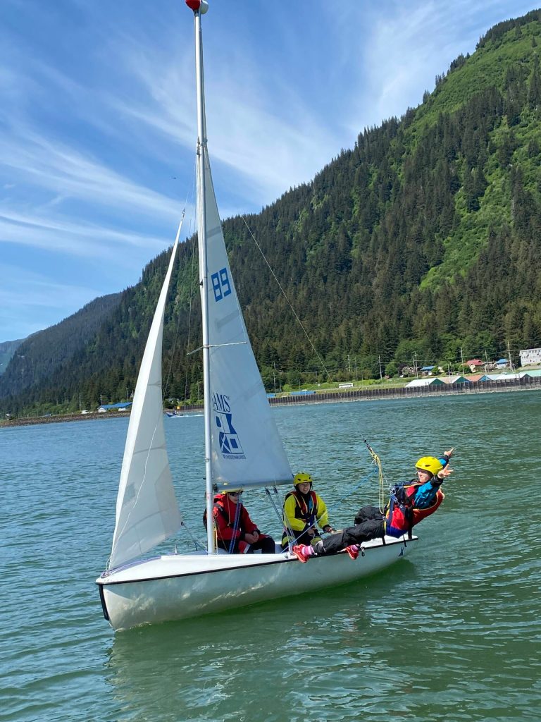 Jack Adams, 15, Lua Mangaccat, 15, and Sigrid Eller, 13, enjoy calm waters in Gastineau Channel during a Juneau Youth Sailing course this week. (Photo by Adrian Whitney)