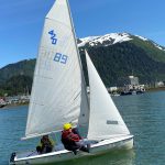 Jack Adams, 15, Lua Mangaccat, 15, and Sigrid Eller, 13, sail within view of downtown Juneau and the surrounding mountains during a Juneau Youth Sailing course this week. (Photo by Adrian Whitney)