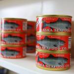 Cans of smoked sockeye salmon line the shelves at the Alaska Seafood Company facility in Lemon Creek. The Central Council of the Tlingit and Haida Indian Tribes of Alaska recently purchased the company and will begin operations by beginning of July, the tribes president told the Empire. (Clarise Larson / Juneau Empire)