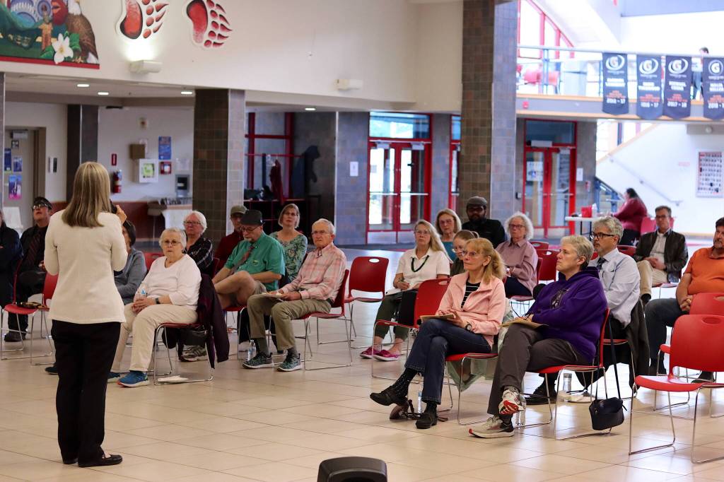 Juneau residents listen to a recap of this years legislative session by state Rep. Andi Story, left, and state Sen. Jesse Kiehl, not pictured, during a legislative town hall Thursday at Juneau-Douglas High School: Yadaa.at Kalé. (Mark Sabbatini / Juneau Empire)