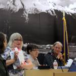 Mayor Beth Weldon flips through an Assembly meeting agenda to give a glimpse at the workload potential candidates for the upcoming election can expect if elected into local office. Weldon was joined by Kristin Bartlett, chief of staff for the Juneau School District (left), Juneau School Board President Deedie Sorenson (middle right) and Mila Cosgrove, former deputy city manager (right), at the City and Borough of Juneaus annual How To Run For Local Office workshop Saturday. (Clarise Larson / Juneau Empire)