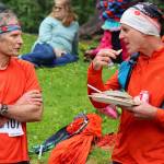 Alex Andrews, right, refuels with pizza and salad while talking with Dan Rondeau after the Juneau Ridge Race at Cope Park on Sunday. (Mark Sabbatini / Juneau Empire)
