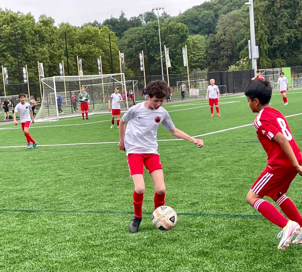 Maddie Dale (white jersey) dribbles the ball as a member of the Juneau Soccer Clubs 2010 Boys team, which included two girls, during a match in the Starfire Spring Classic soccer tournament in Seattle earlier this month. (Photo courtesy of Juneau Soccer Club)