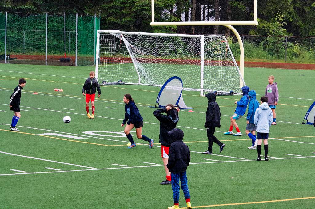 Juneau Soccer Club participants practice in the rain Monday at Adair-Kennedy Memorial Park. (Therese Pokorney / Juneau Empire)