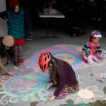 Therese Pokorney / Juneau Empire
Children draw chalk pictures in the Douglas Library parking garage on Saturday as part of a gathering to prepare for July 4 events in Douglas.