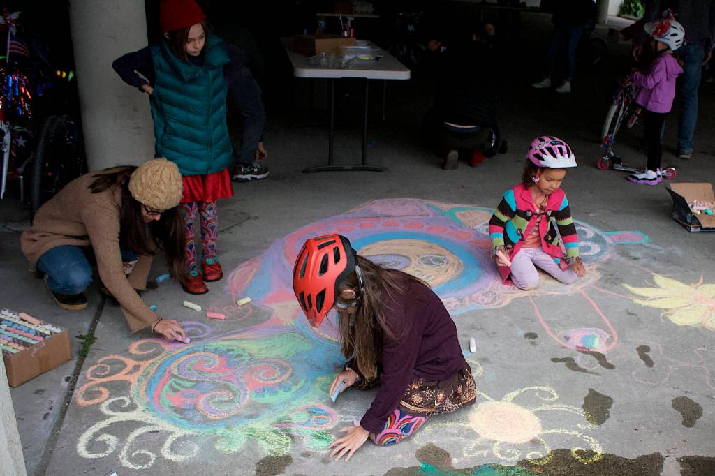 Therese Pokorney / Juneau Empire
Children draw chalk pictures in the Douglas Library parking garage on Saturday as part of a gathering to prepare for July 4 events in Douglas.