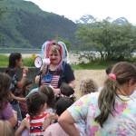 Maggie Swanson, president of the Douglas Fourth of July committee, gives instructions to youths about to participate in a sand dollar search on Sandy Beach during a community picnic Monday evening. (Therese Pokorney / Juneau Empire)