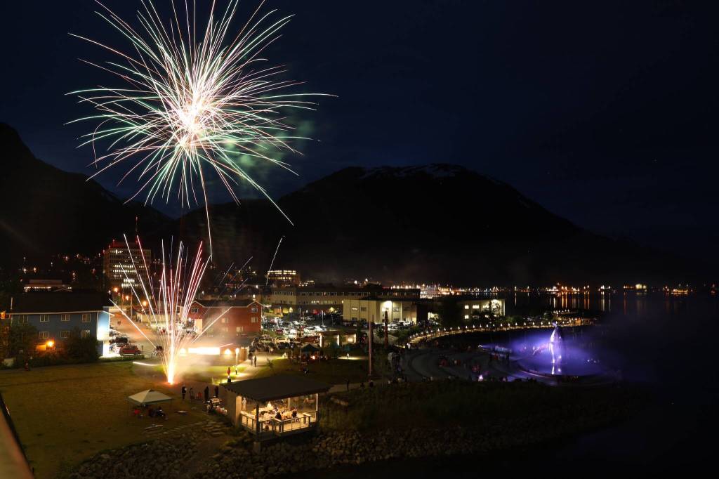 Fireworks boom above Tahku the whale sculpture and downtown during the annual Fourth of July firework display over Gastineau Channel. (Clarise Larson / Juneau Empire)