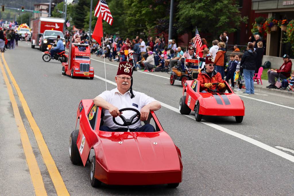 Members of the Juneau-Douglas Shrine Club drive miniature cars during the Fourth of July parade in downtown Juneau on Tuesday. (Mark Sabbatini / Juneau Empire)