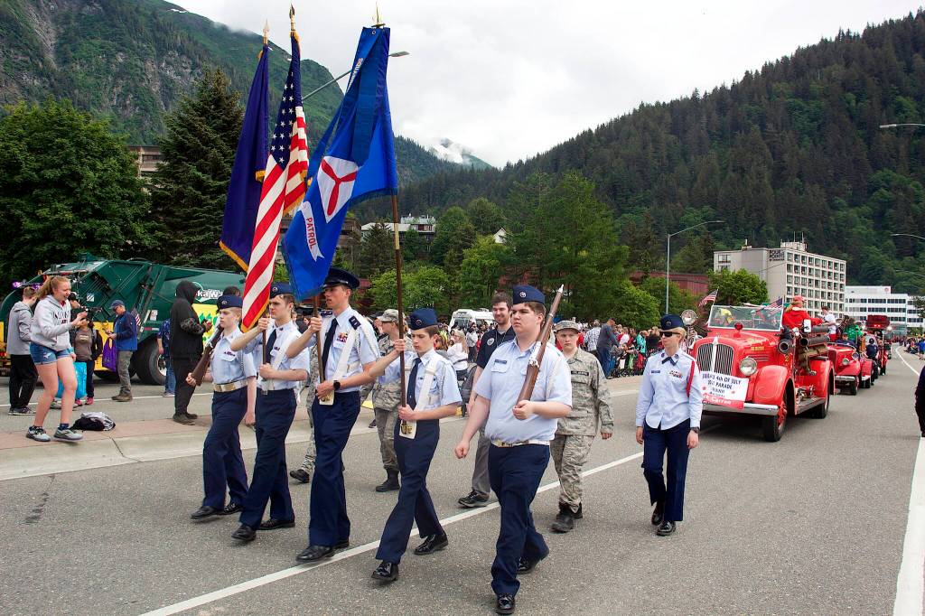 A color guard leads dozens of floats through downtown Juneau on Tuesday during the annual Fourth of July Parade. The parade took about an hour to pass people watching all of the participants from a fixed location. (Mark Sabbatini / Juneau Empire)