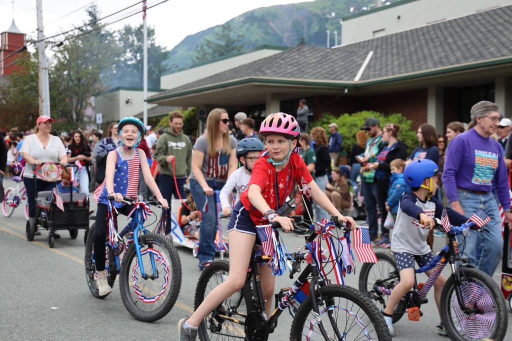 Young residents ride their patriotically decorated bikes/trikes/scooters Tuesday afternoon during the annual Fourth of July parade in Douglas. (Clarise Larson / Juneau Empire)