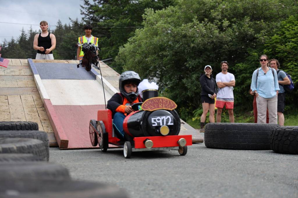 Ottavio Snyder rolls full steam ahead in his Hogwarts-themed soapbox car during the Final Soapbox Challenge Tuesday afternoon down St. Anns Avenue in Douglas. (Clarise Larson / Juneau Empire)
